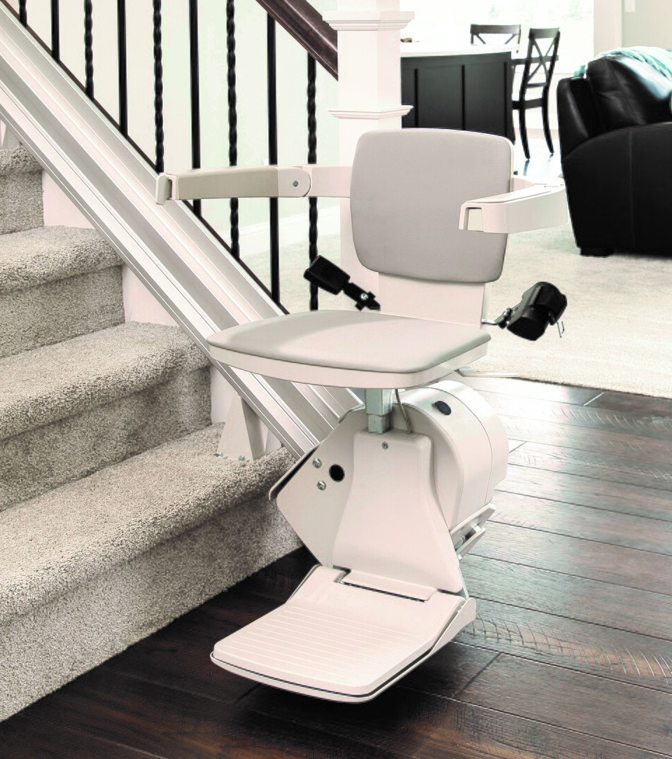 Bruno Elan chair stairlift on a straight indoor staircase, with the seat, armrests and rail visible